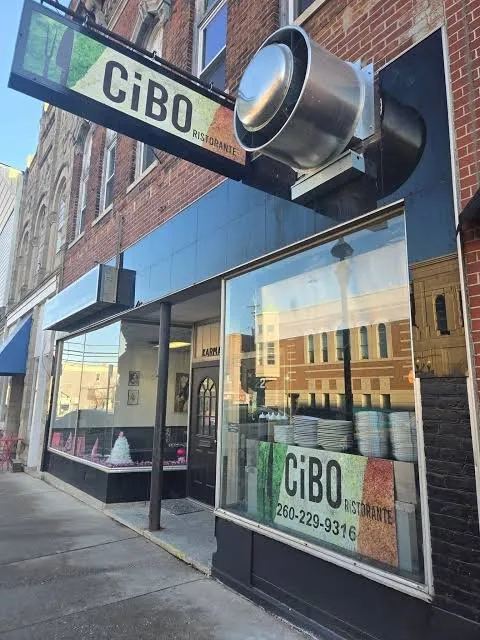 The CiBO Ristorante sign over the black storefront at 223 W Van Buren, stacked plates in the front window.